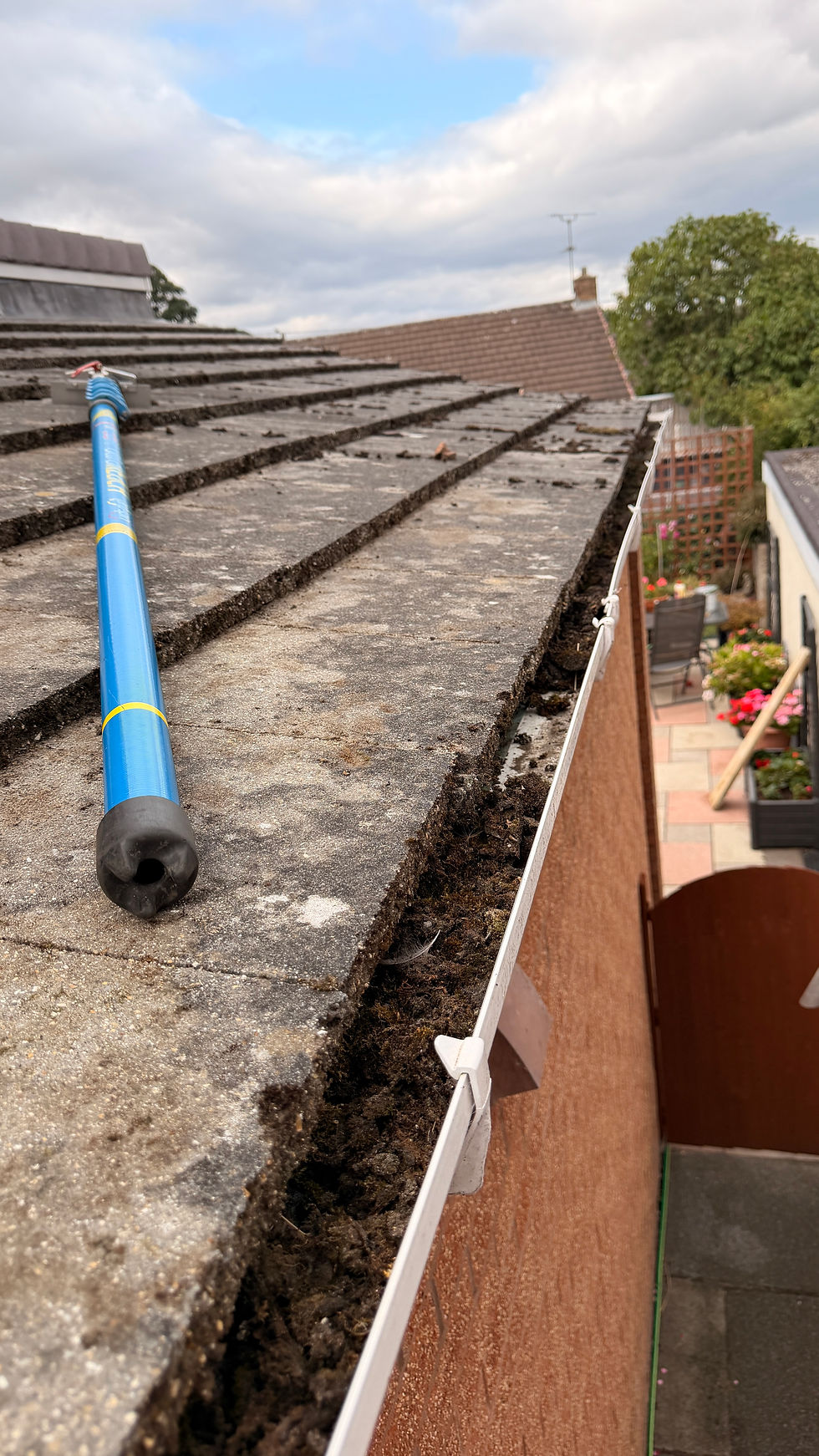 Manual roof moss scraping and removal in Flintshire
