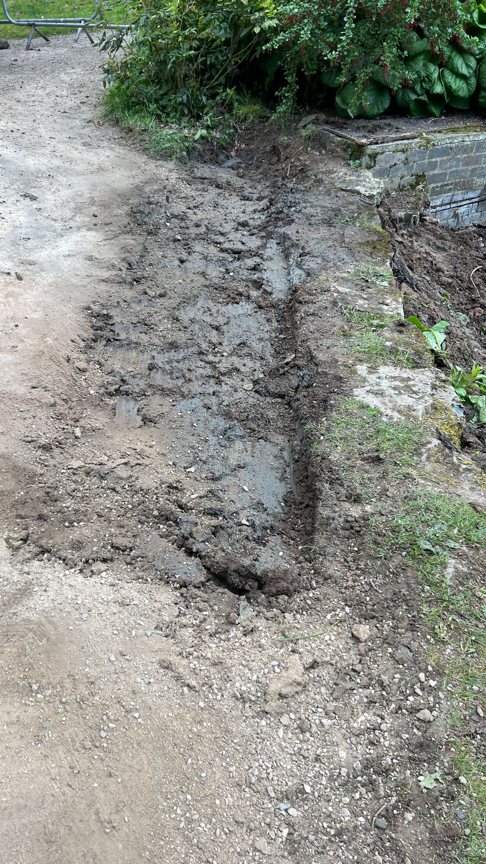 Groundworks excavation project using mini digger to fix dam face 