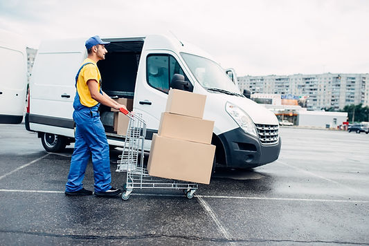 6523d1655c1a2b5a1ef544d4_courier-with-parcel-trolley-against-logistic-truck-2021-08-26-16-