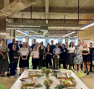 Empty morning tea boxes by Something Sigrid after delivery for Lyons, with a happy team of 80 smiling in the background.