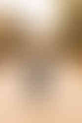 Mansfield high school student throwing cap while wearing her graduation outfit in front of the Drover hotel