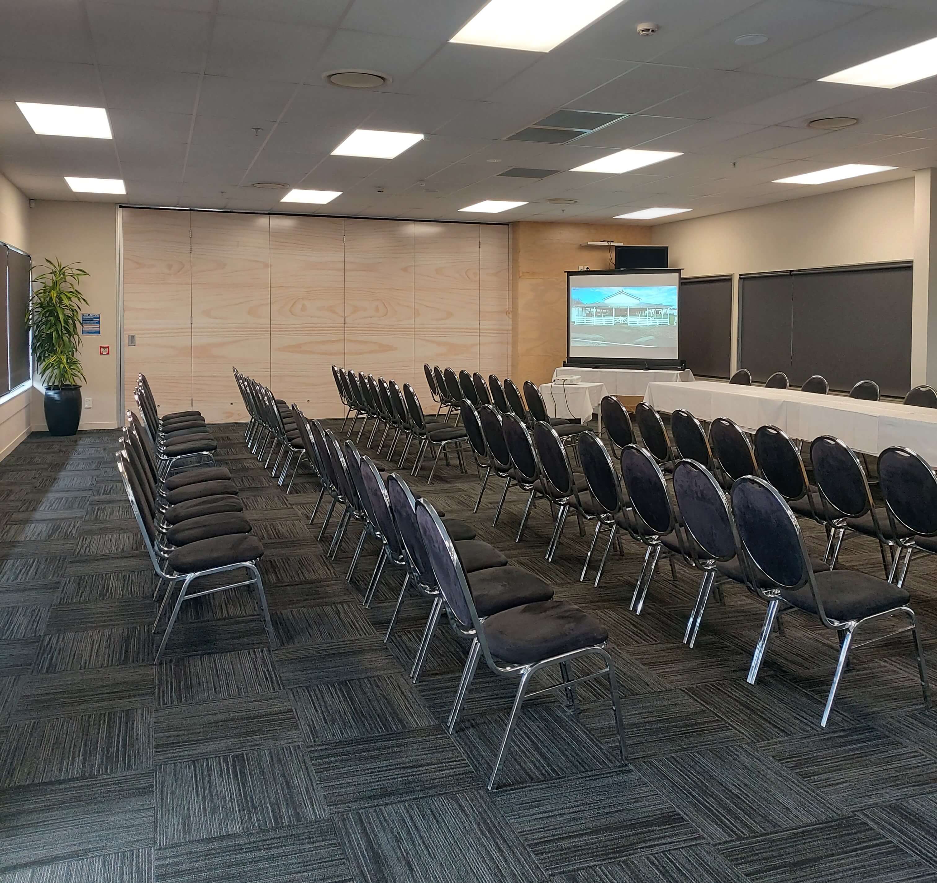 Empty conference room with rows of chairs ready for conferences.