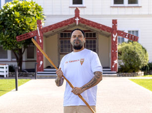 Wetini Herewini, Pūkenga for Te Whare Tapere, holding a taiaha