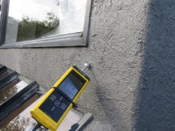 Moisture meter testing exterior wall