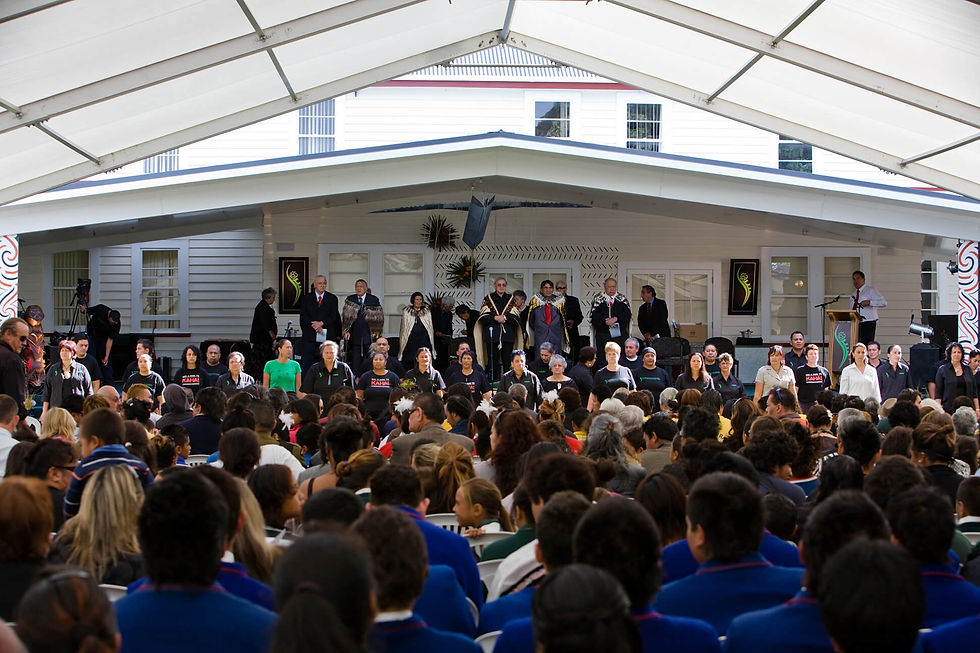 Crowd gathered under a marquee for a formal Mō Mātou event.