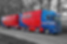 Red and blue Midlands Livestock Transport truck on road with text.
