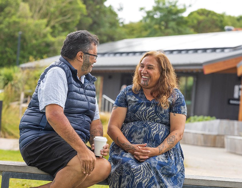 Man and woman smiling and talking together outdoors