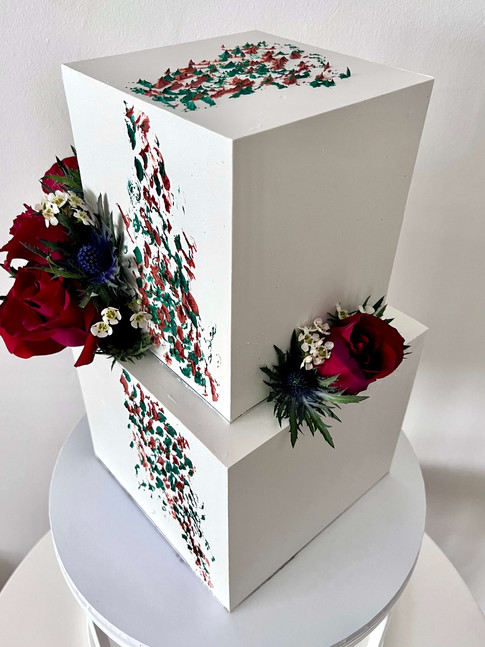Square tiered bespoke wedding cake decorated with fresh flowers and textured buttercream