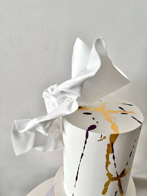 2 tier wedding cake with pink watercolour effect, painted gold kintsugi and moulded wafer paper