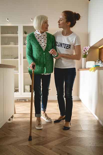 A Volunteer Hospice worker assisting an elderly hospice care patient