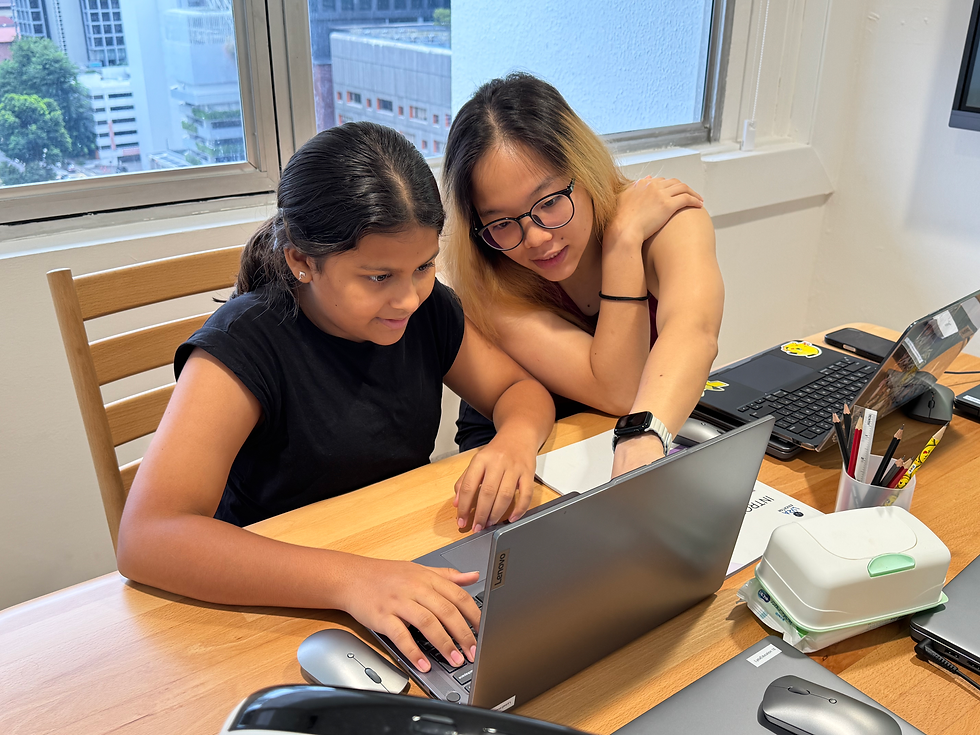 Student learning Python programming with guidance from a teacher in the classroom.