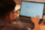 Student checking and correcting his Python coding mistake.