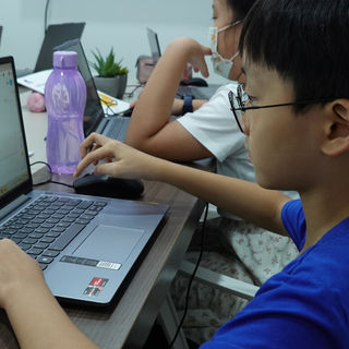 Boy coding in our L303 Python class creating their own Python projects.