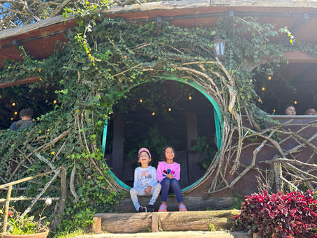 Child running through hobbit-style house at Hobbitenango eco-park