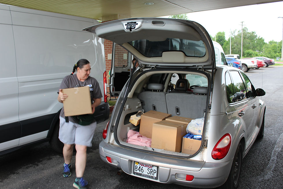 Volunteer Bessie Mitchell loads a vehicle recently at the Senior Mobile Unit site at the Benton County Senior Activity and Wellness Center, 3501 SE L St., Bentonville.
