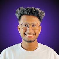 Smiling man with glasses and textured hair