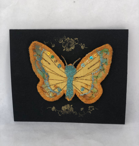 Gold and turquoise brooch on card