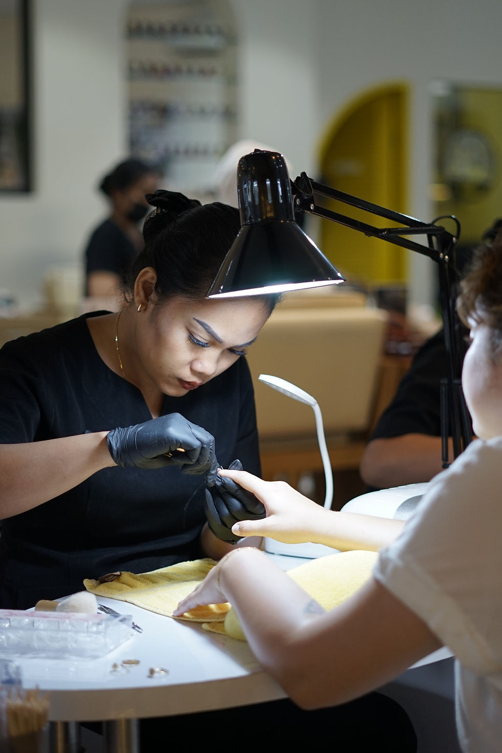 Nail salon Bali at The Shampoo Lounge expert nail technician performing gel manicure and nail art at premium beauty salon in Seminyak Bali