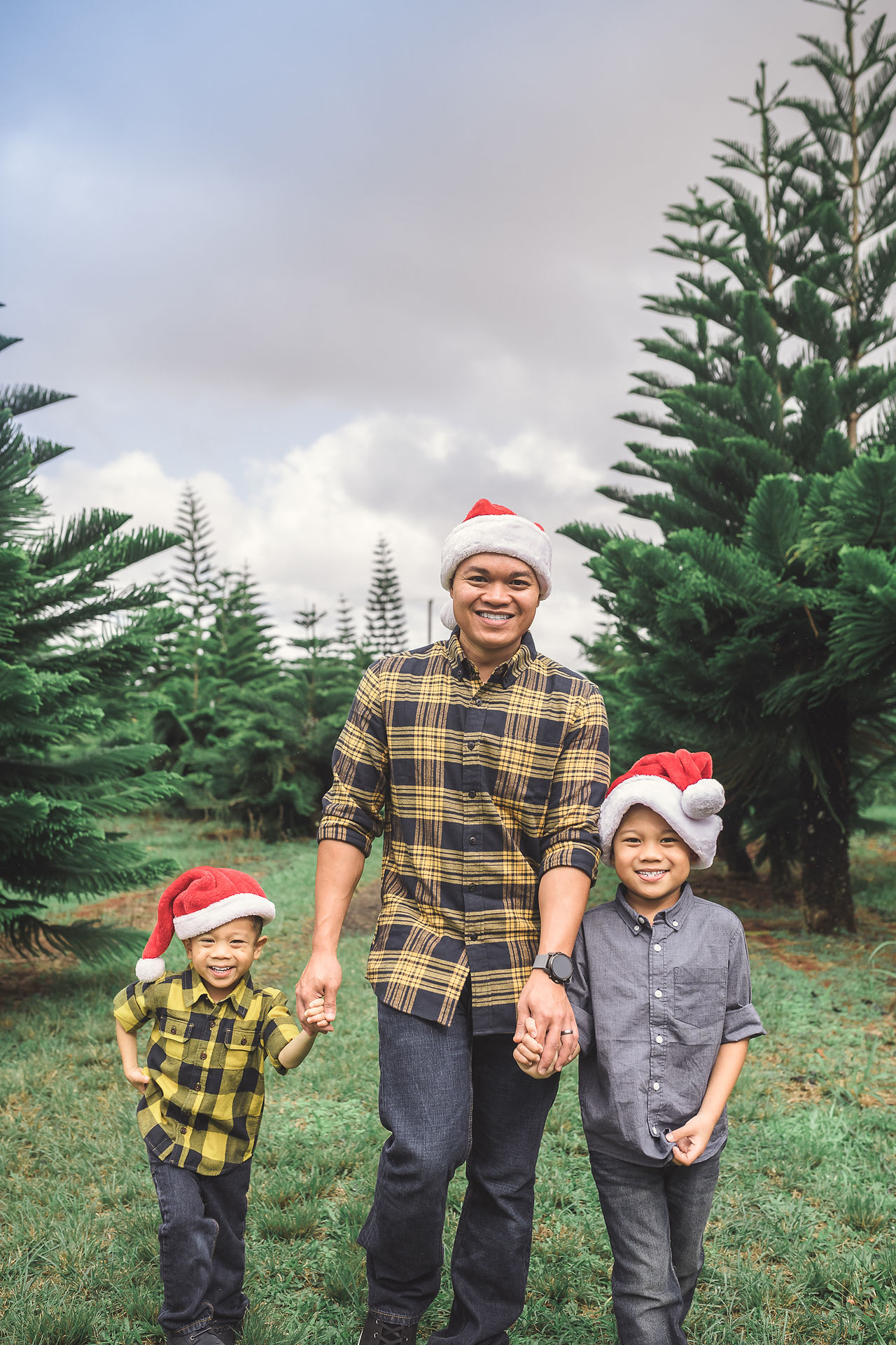 Dad with kids wearing santa hats