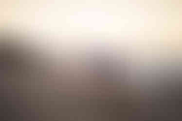 Father and daughters holding hands walking along the beach