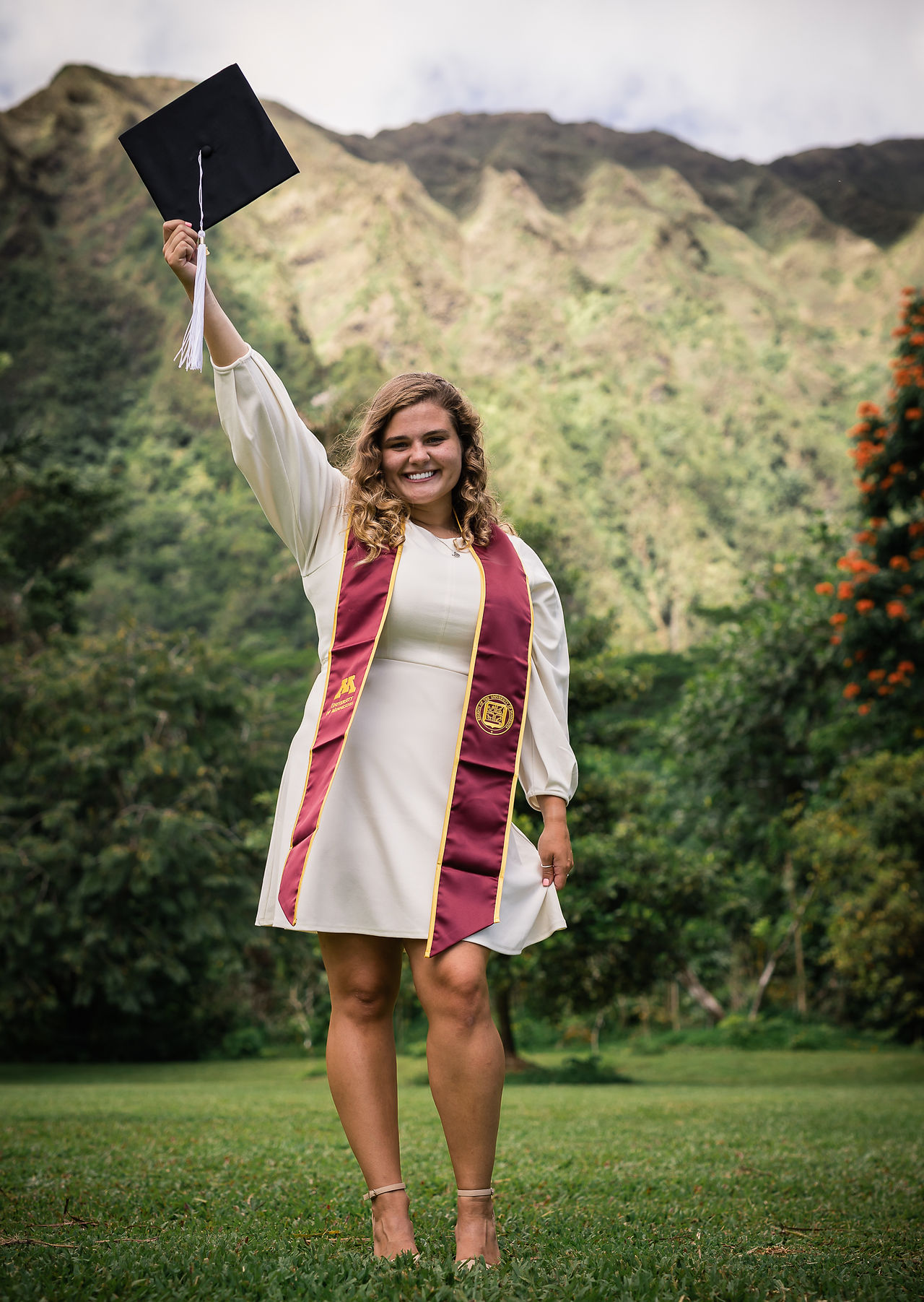 senior graduate with arm up