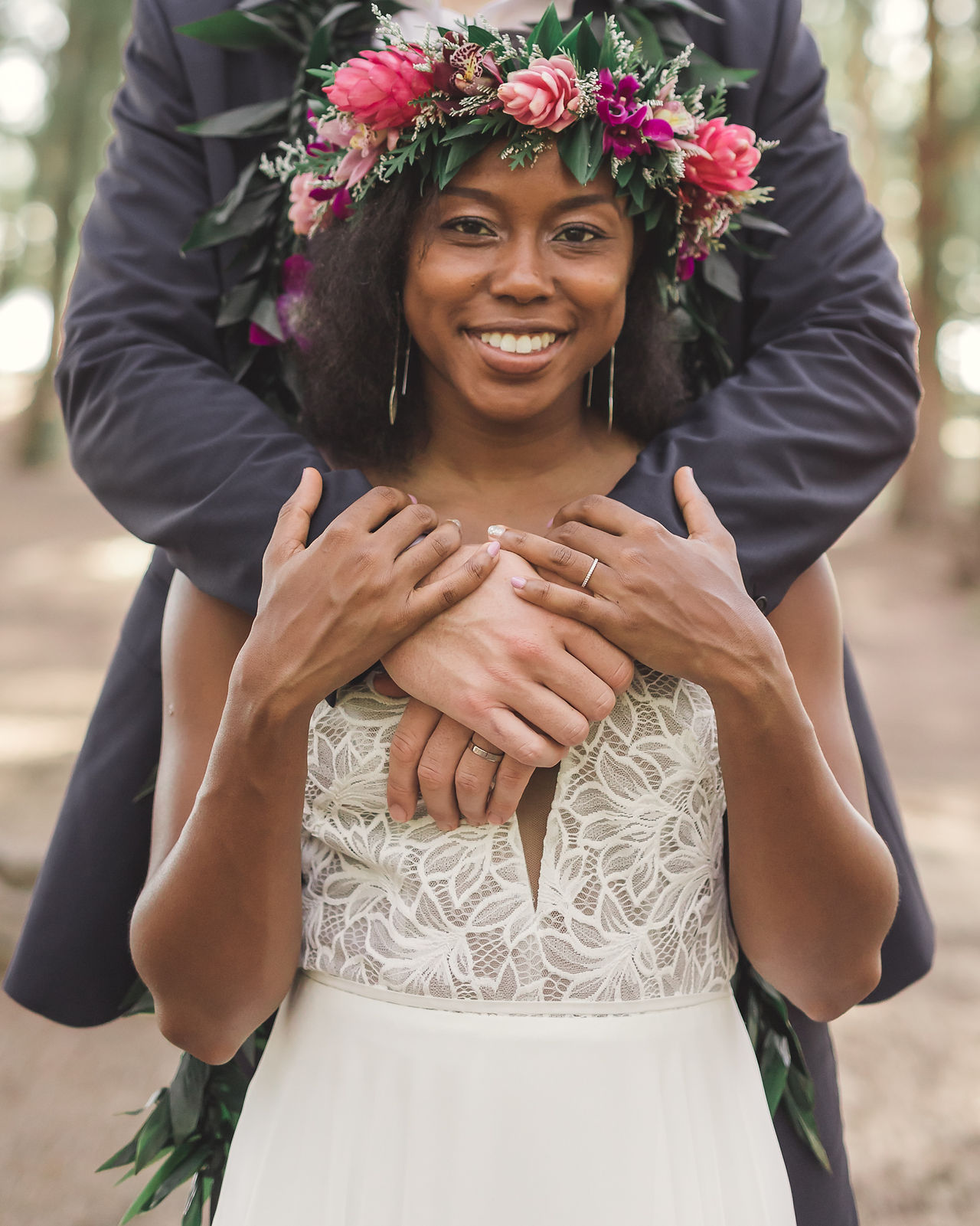 Groom hugging bride from behind