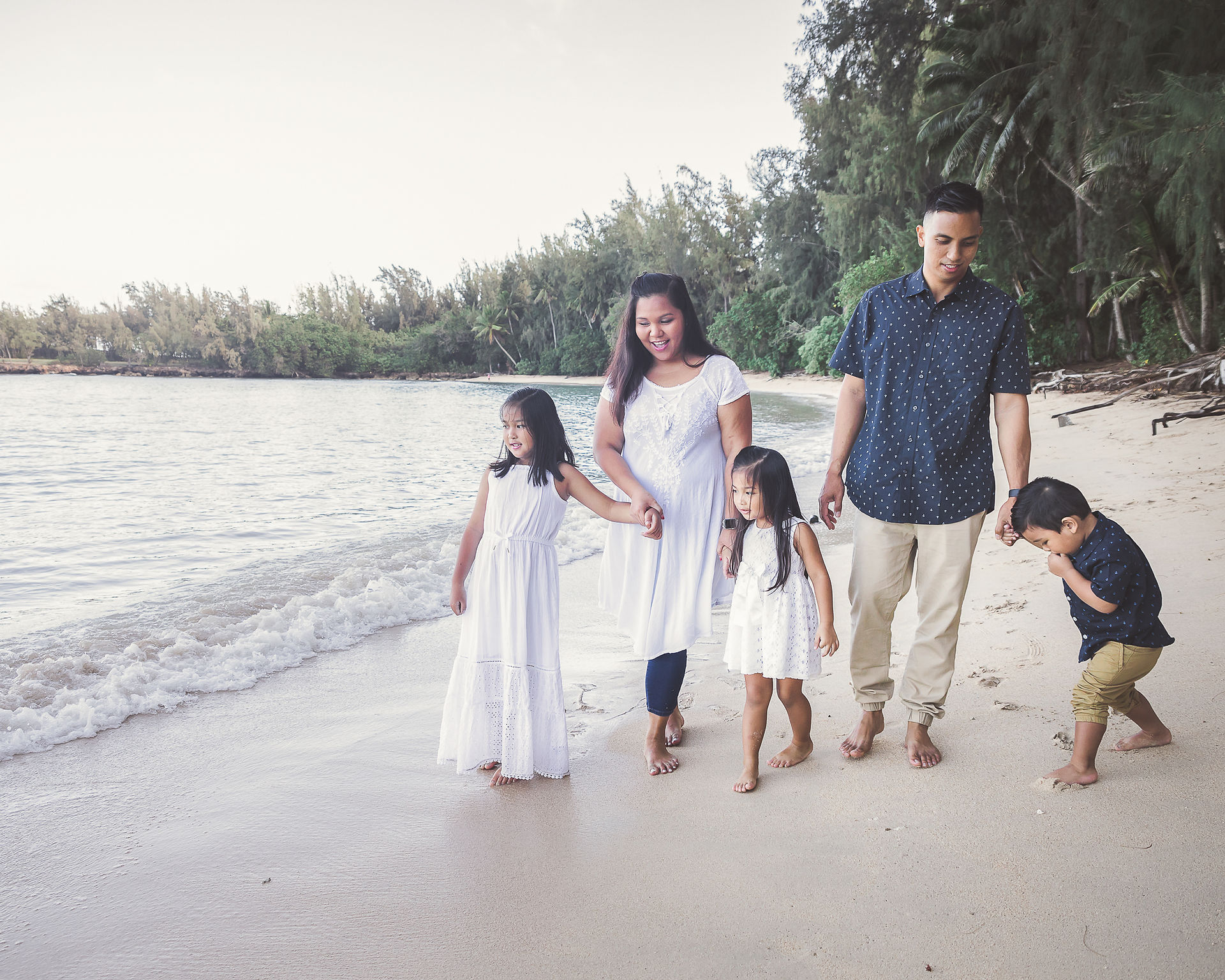 Family of five walking along the beach