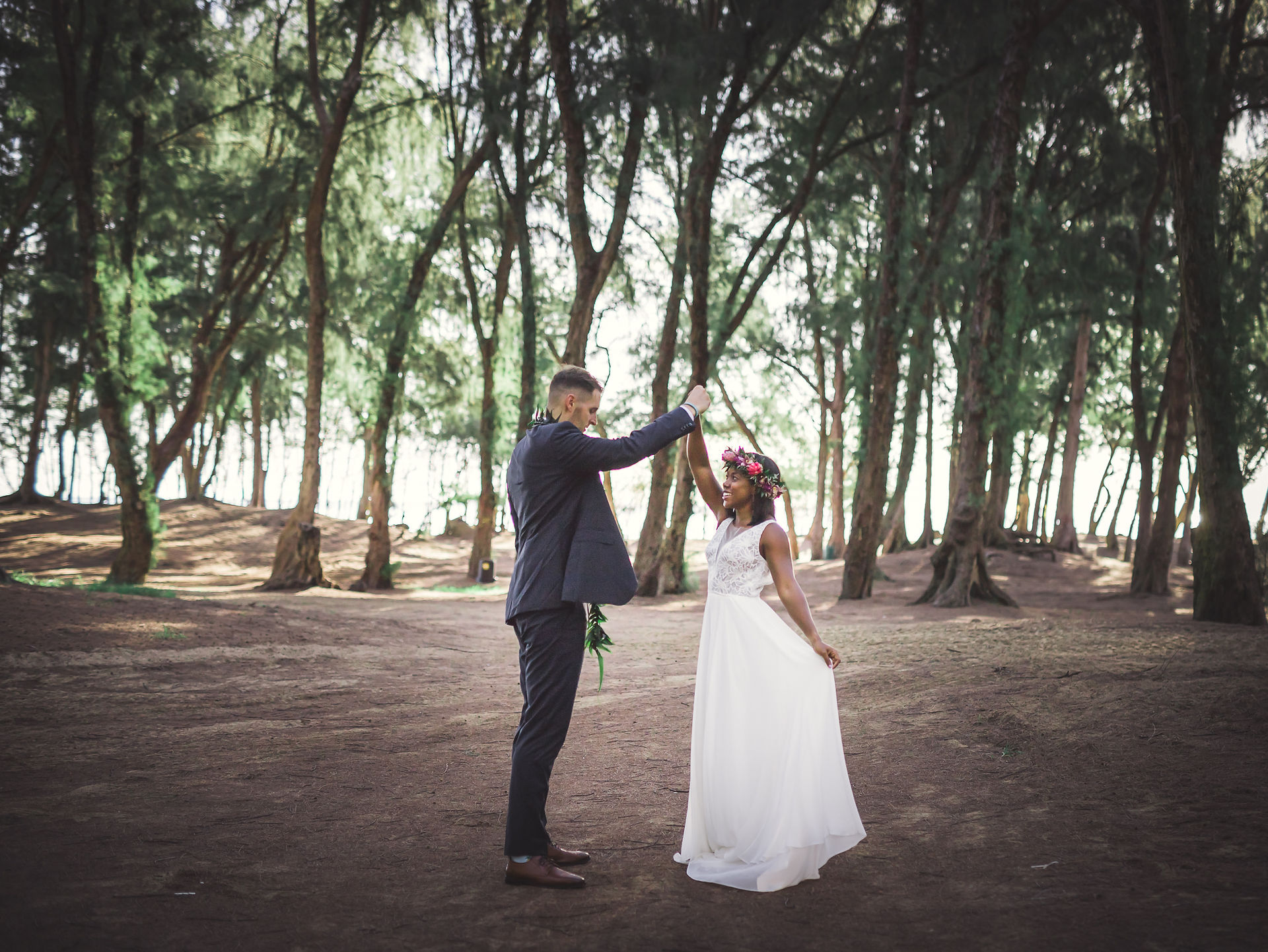 Newlyweds dancing in the wooded area