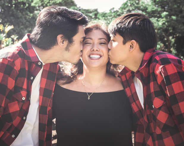 Sons giving mom a kiss on the cheek