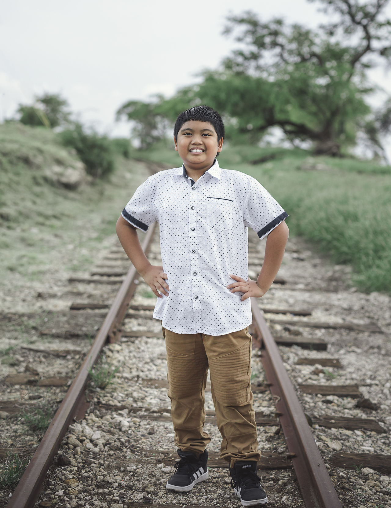 Oldest son portrait on an old train track