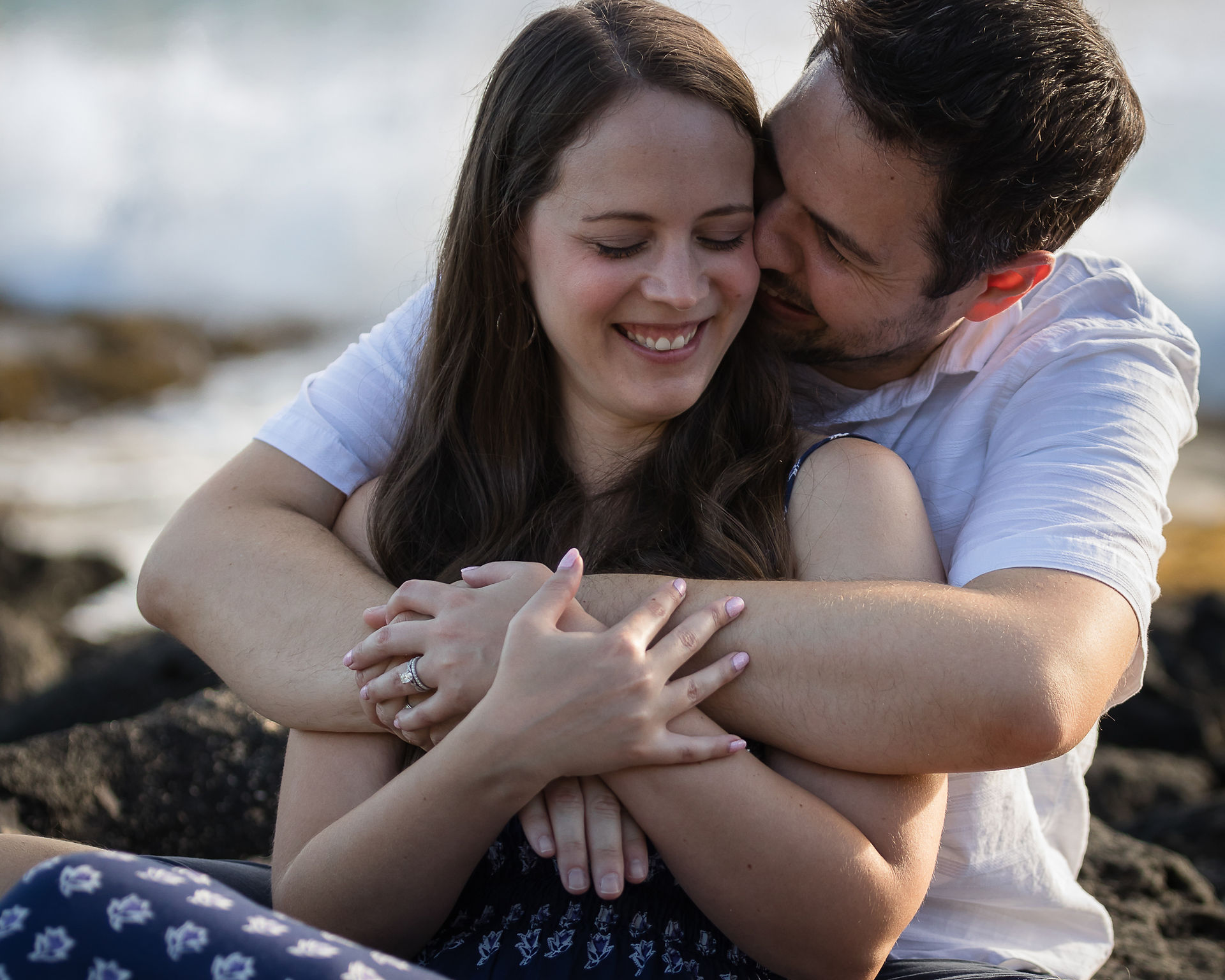 husband whispering something in wife's ear