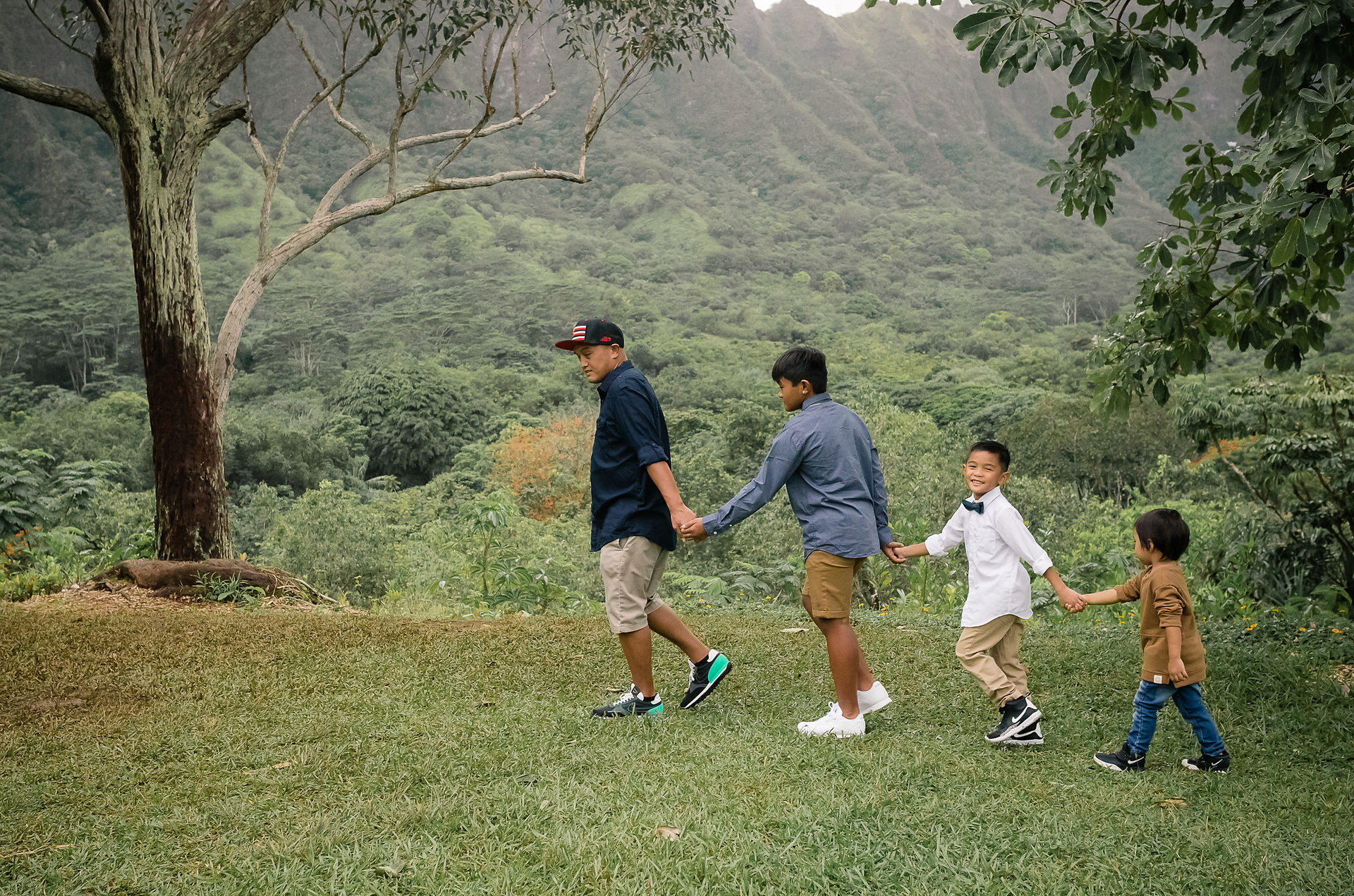Dad and son's holding hands following the leader
