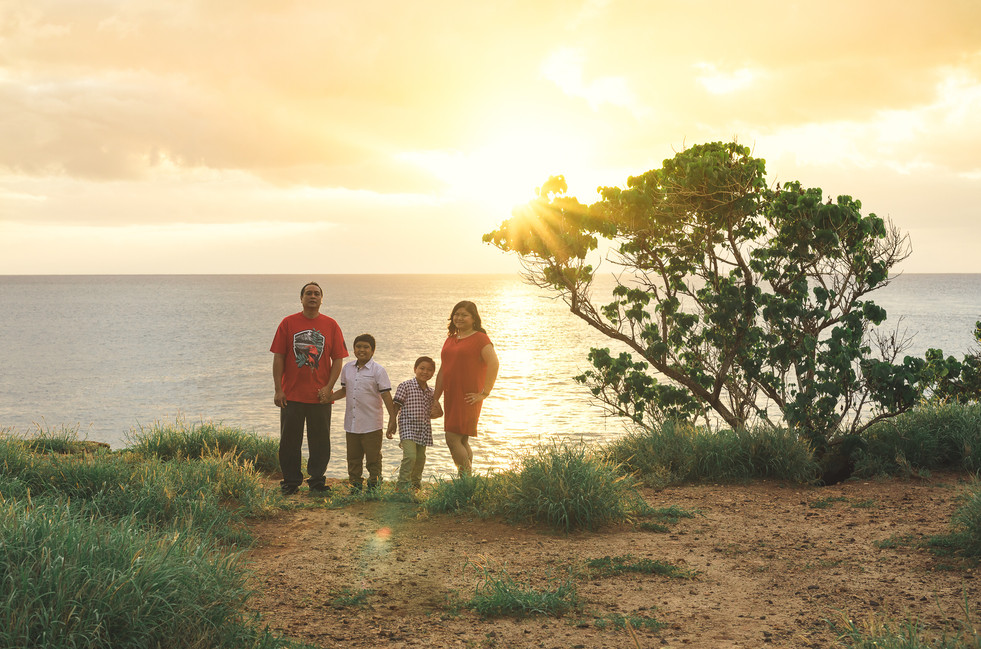 Family posing at sunset