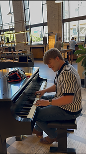 Lucas Strange performing on a grand piano