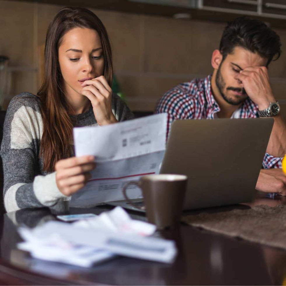 A couple stressfully reviews their rising utility bills.