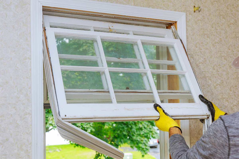 A window technician removes windows from an old home.
