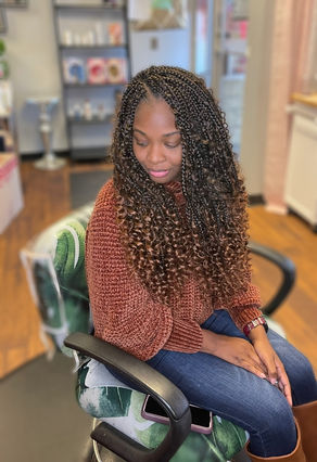 Long curly crochet braids with a natural-looking center part