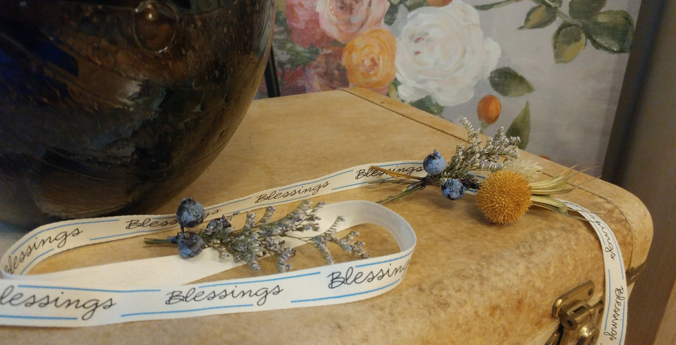 floral decoration with a linen ribbon with the handwritten word Blessings