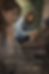 A woman kneels, giving food to a homeless man on a street. Another image of her is overlayed, appearing reflective. Text reads: True humility... The Path of the Heart: Living the Seven Virtues of Mary