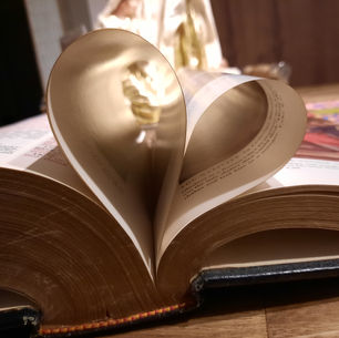 an open Bible an a heart made from pages as a symbol of love and blessings.