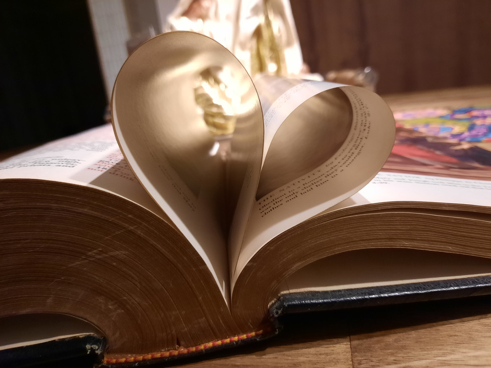 an open Bible, two pages fold into a heart symbolizing blessings from God.
