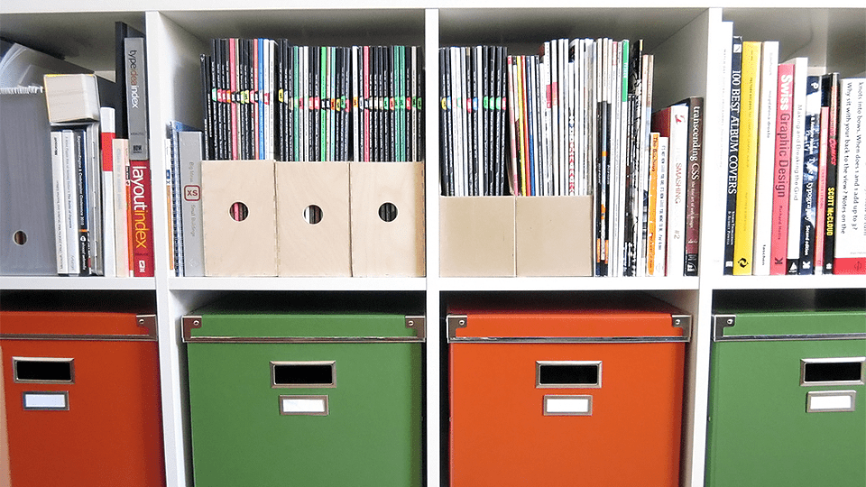 Organized Rows of Colorful Comic Books in Protective Boxes on a Shelf