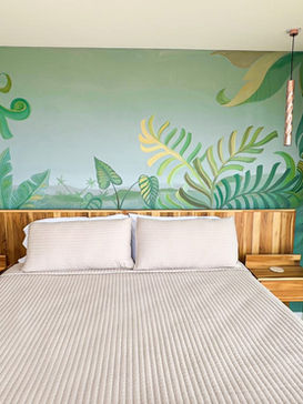 Modern bedroom with tropical mural and ocean view balcony