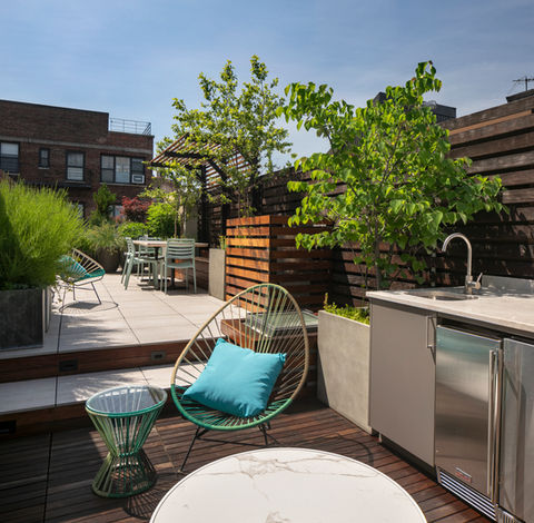 This project on the rooftop of a West Village townhouse has transformed the space into a serene urban oasis. New, sleek pavers create a stylish foundation, while carefully curated plantings add vibrant greenery and texture, enhancing the tranquil atmosphere. A beautifully crafted pergola provides shade and a cozy retreat, perfect for relaxing or entertaining. To complete the transformation, an Urban Bonfire outdoor kitchen invites gatherings, featuring a modern grill and seating area. This rooftop haven seamlessly blends nature and urban living.