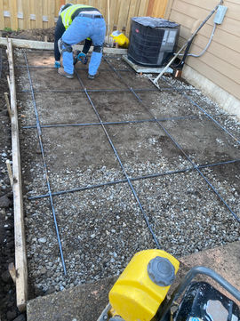 Pacific NW Concrete installed a retaining wall and patio extension at this Beaverton home, transforming a sloped backyard into a functional, level space with an exposed aggregate finish.