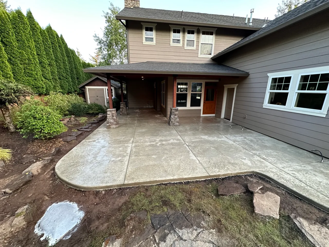Curved concrete patio featuring stained, stamped concrete