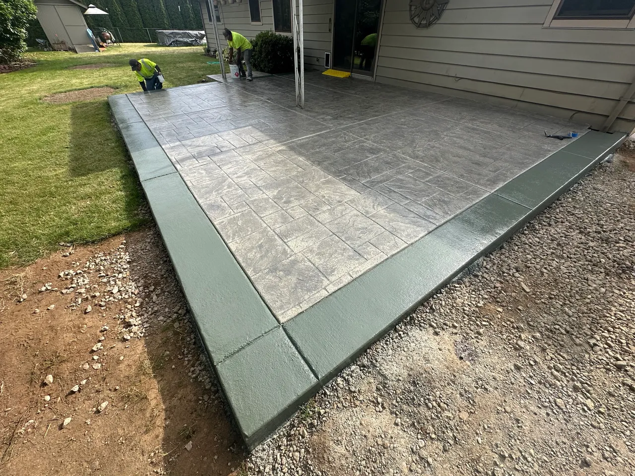 Stamped concrete patio with broom finish boarder detail