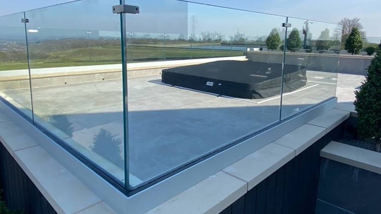 Rooftop patio with a beautiful countryside view and a frameless glass balusdae around the outside
