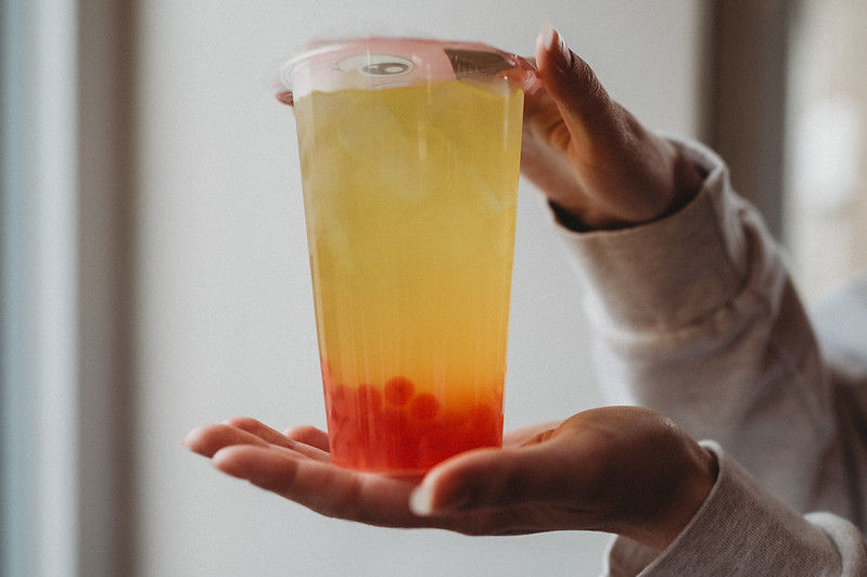 Mango bubble tea with strawberry boba.jpg