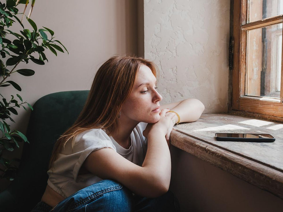 woman looking at her phone feeling unsure